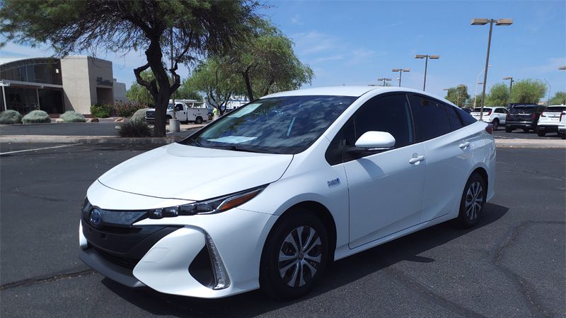 Close-up view of the Toyota Prius Prime LE, featuring its sleek design and plug-in hybrid technology.