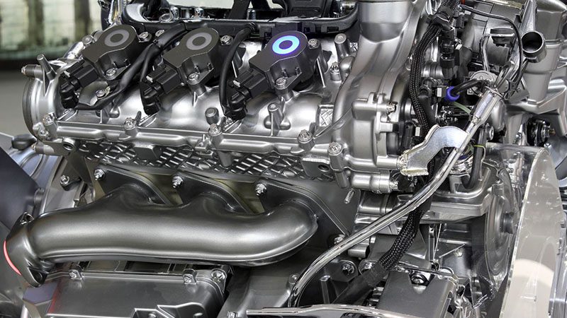 Close-up of a powerful V6 car engine, showcasing its robust design and performance components.