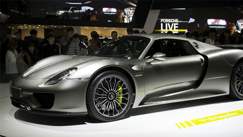 Close-up view of a luxury car on display at an auto parts trade show, highlighting automotive design and innovation