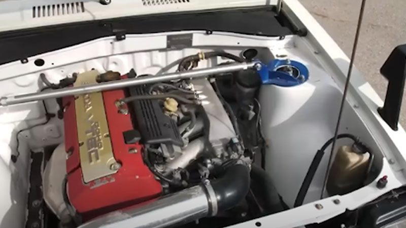 Close-up of a VTEC engine in a clean engine bay, highlighting the valve timing system and polished components.