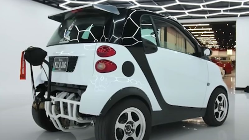 Close-up of a Smart Car, focusing on its compact design and front-end detailing.