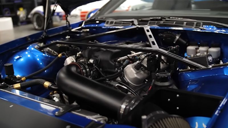 Close-up of an LS engine, showcasing its intake manifold, valve covers, and performance components.