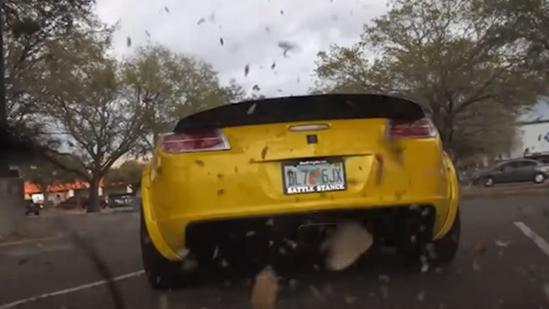 Close-up of a car's rear end with a 2JZ engine swap setup.