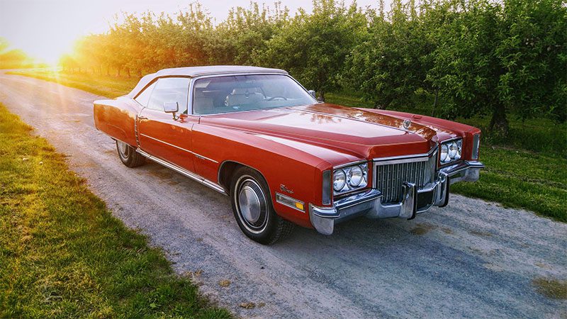 Old red Cadillac Eldorado in the sun