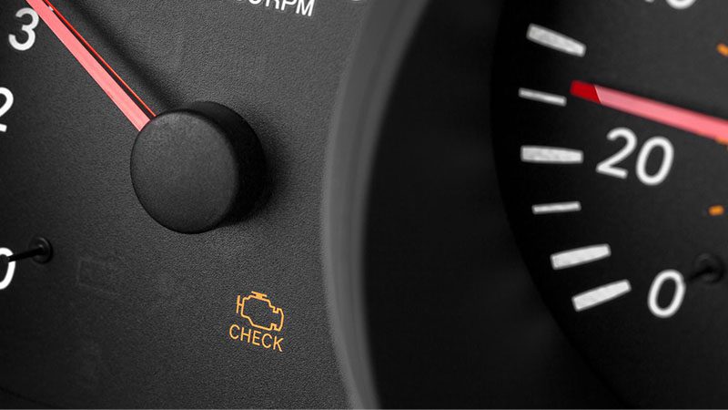 Check engine warning light illuminated on vehicle dashboard.