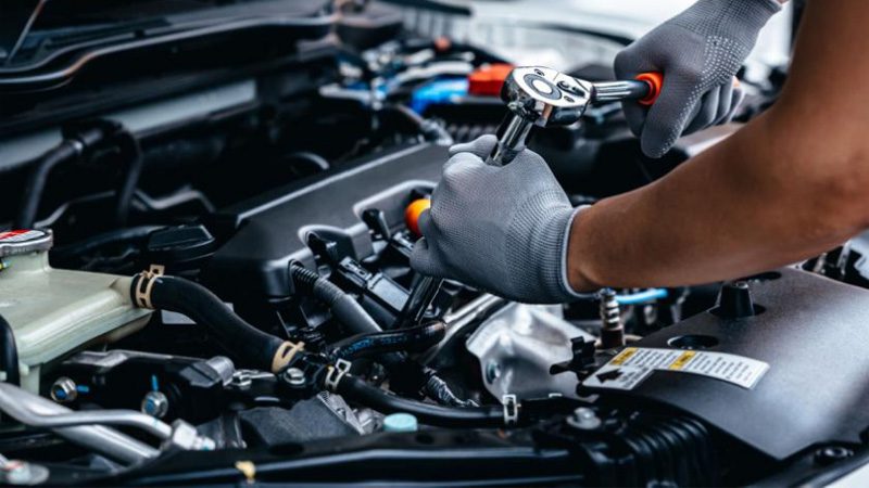 Mechanic maintaining the Chevy fuel system, ensuring proper function and efficiency for optimal engine performance.