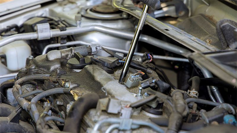 Mechanic diagnosing and repairing a faulty engine to restore optimal performance.