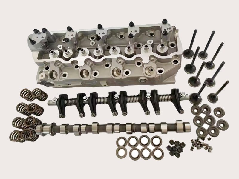 Diagram showing the disassembly of cylinder head components, including valves, valve springs, camshaft, and rocker arms.