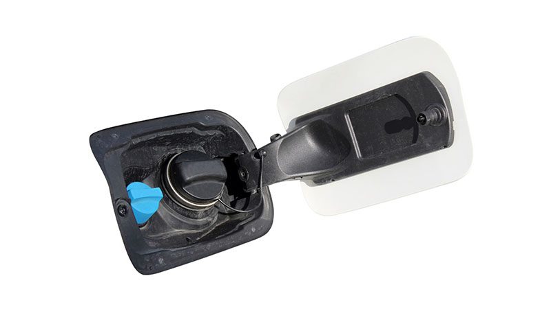 Close-up view of Diesel Exhaust Fluid (DEF) fill port and diesel fuel cap on a vehicle