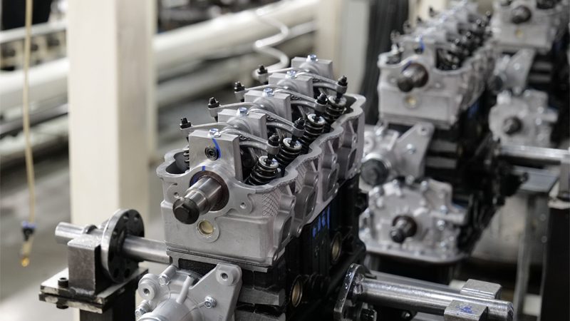 Engine being assembled on the production line at Nanjing Woda Auto Technology Co., Ltd., highlighting precision manufacturing of engine components.