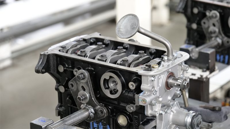 Close-up of the engine production line at Nanjing Woda Auto Technology Co., Ltd.'s factory, showcasing the high-quality engine parts produced for optimal performance.