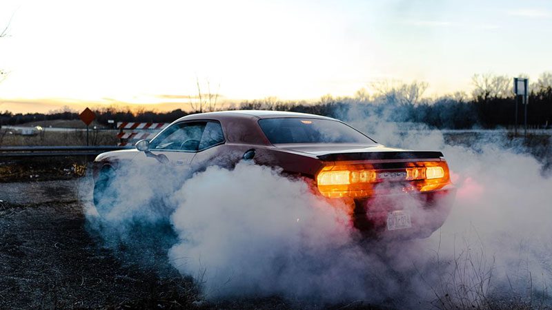 White smoke coming out of a car’s exhaust, indicating unburned diesel fuel or possible coolant leak