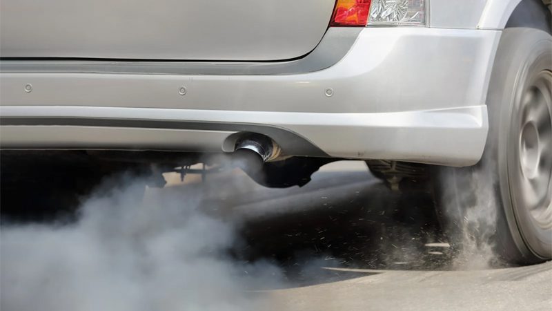 Air pollution caused by exhaust emissions from a vehicle’s tailpipe on the road.