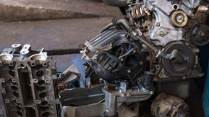 Damage assessment on an engine during the overhaul process, identifying areas requiring repair or replacement.