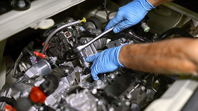 Mechanic working on an engine overhaul, restoring performance and ensuring engine longevity.