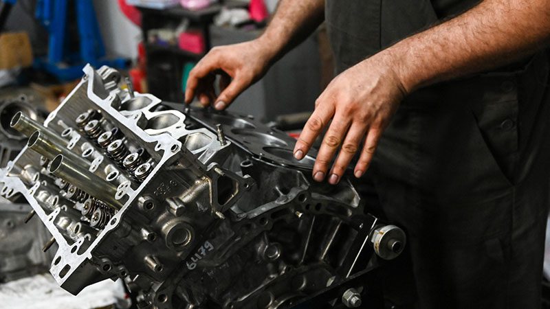 Mechanic inspecting an engine to ensure optimal performance and reliability.