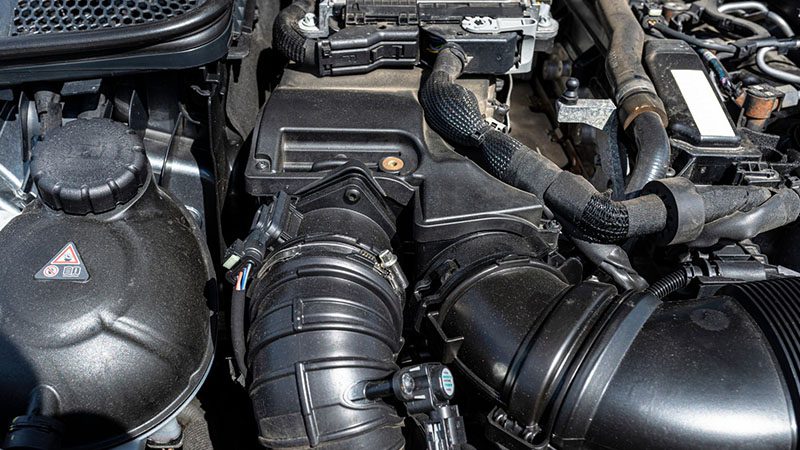 Close-up of an engine, highlighting detailed components relevant to engine specifications.