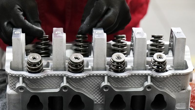 Cylinder head assembly line at Nanjing Woda Auto Technology's factory, showcasing precision manufacturing of engine components.