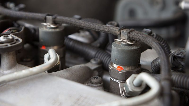 Close-up of diesel engine fuel injection nozzle showing precision injector component.