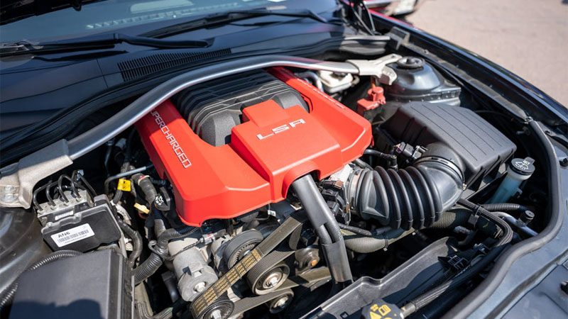 Detailed view of a supercharged LSA engine installed in a car, highlighting high-performance components.
