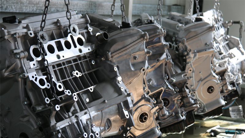 Engine assembly on production line at Nanjing Woda Auto Technology Co., Ltd, showcasing precision manufacturing of fuel injection and carburetor systems.
