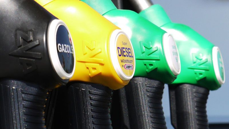 Diesel and gasoline fuel injectors at a gas station pump.