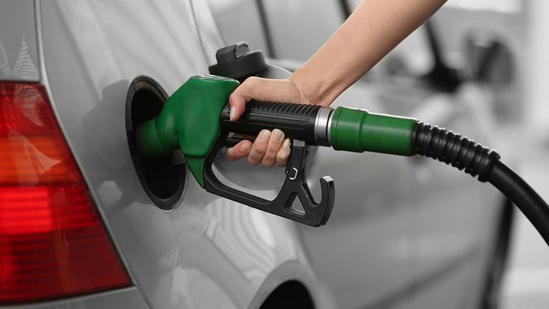 Car being refueled at a gas station.