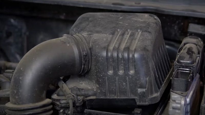 Close-up of the air box housing that contains the car’s engine air filter.