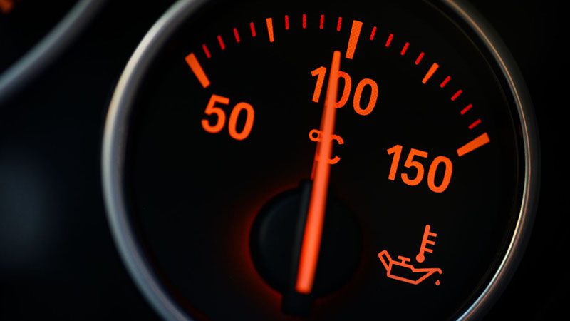 Close-up detail of a car coolant gauge showing fluid level indicator.