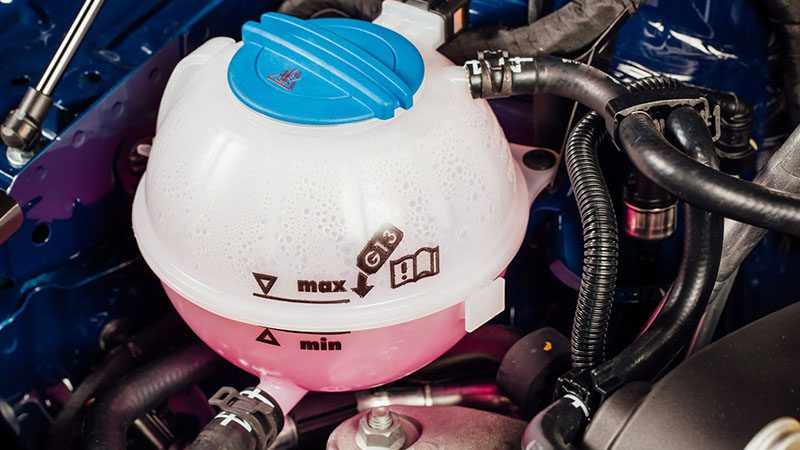 Coolant antifreeze tank located under the car’s engine hood.
