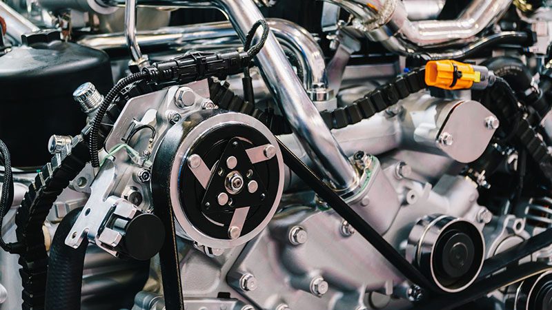 Close-up of truck engine motor components during a car service inspection