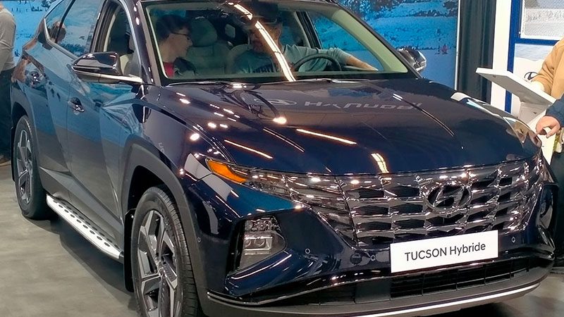 Close-up of a Hyundai Tucson Hybrid, showcasing its sleek exterior design and hybrid badge.