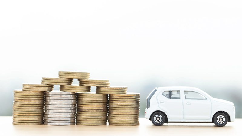 Concept image of car investment, featuring a car with financial documents or currency symbols in the background.