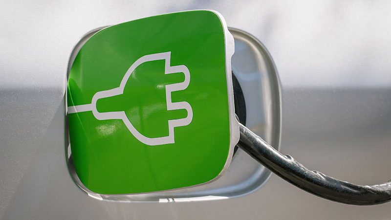 Close-up of a car charging port, highlighting its eco-friendly design for electric or hybrid vehicles.