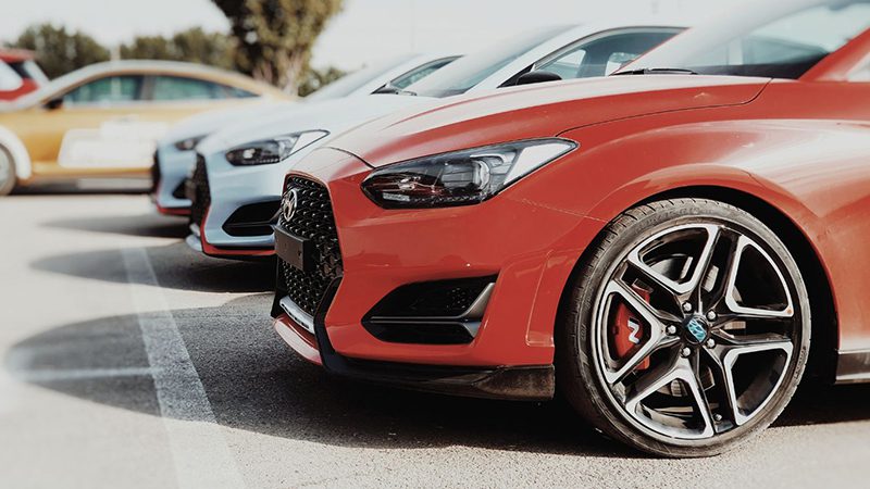 Close-up view of a parked Hyundai car showing front grille and headlight design.