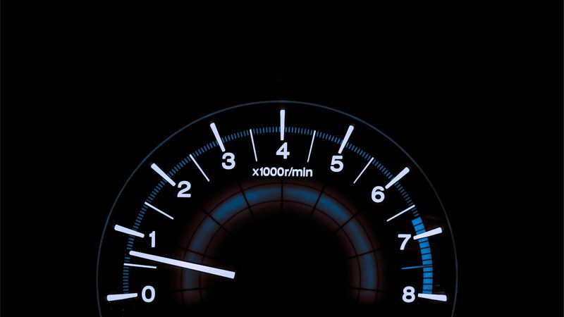 Close-up of a car's dashboard, showcasing the various gauges and controls for monitoring vehicle performance.