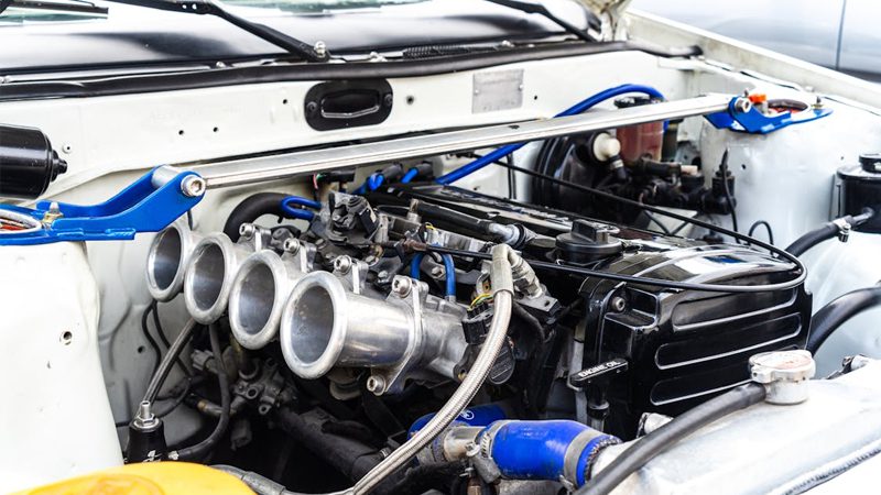 Close-up of a car's engine, highlighting its complex components and intricate design for optimal vehicle performance.