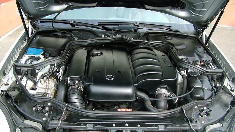 Close-up of a car engine's intake manifold, highlighting its detailed structure.