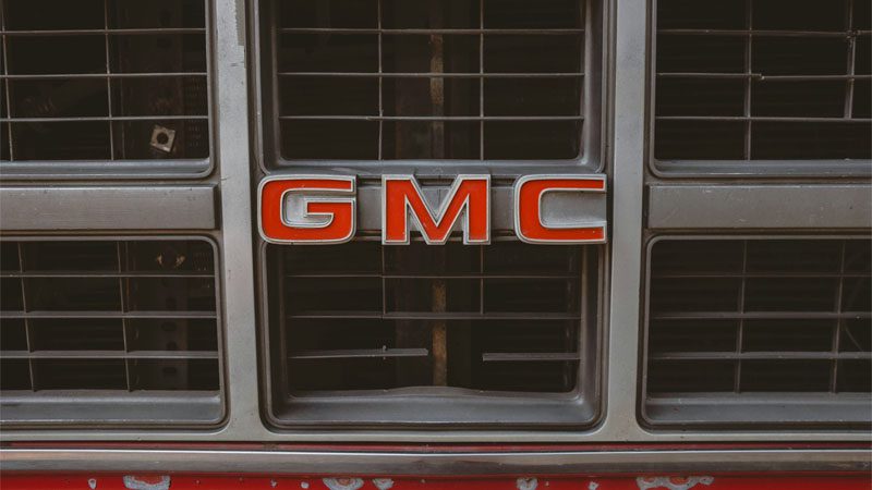 A close up of the grilles of a GMC truck.