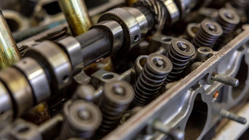 Detailed view of an engine camshaft and valve springs, showcasing mechanical precision.