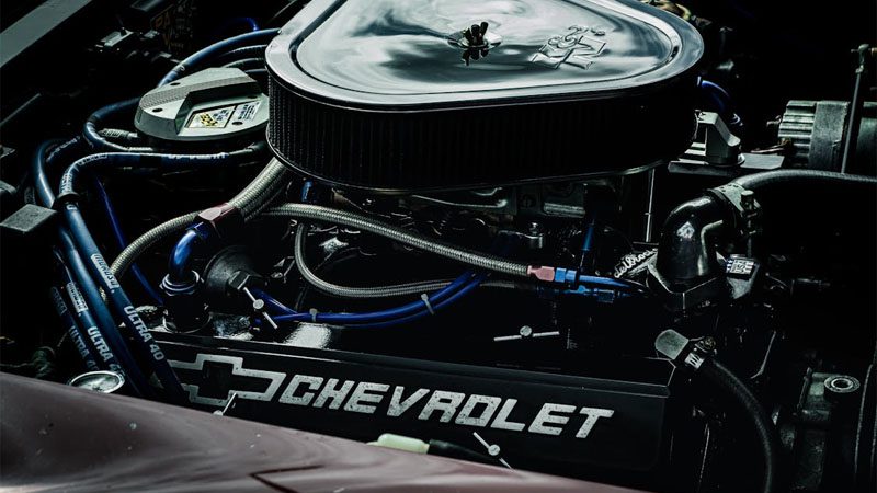 Detailed close-up of a Chevrolet engine showcasing performance parts and intricate mechanics.
