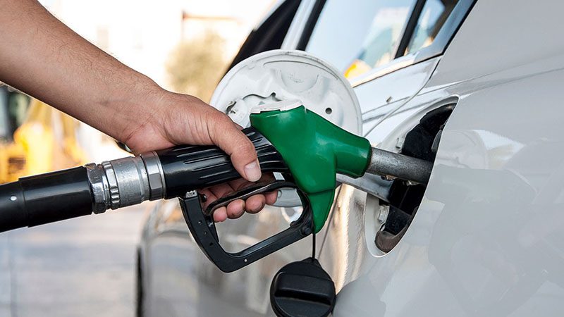 Fueling up a pickup truck at a gas station – Emphasizing the importance of fuel efficiency for cost savings and performance.