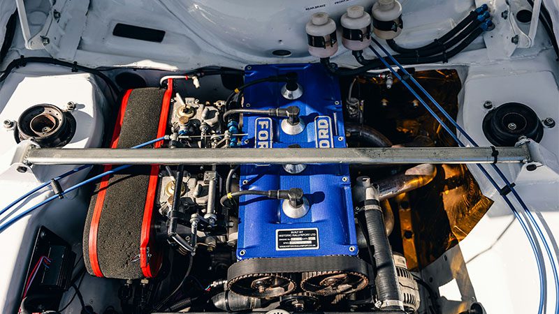 Ford engine bay with distinctive blue covers, showcasing engine design and layout.