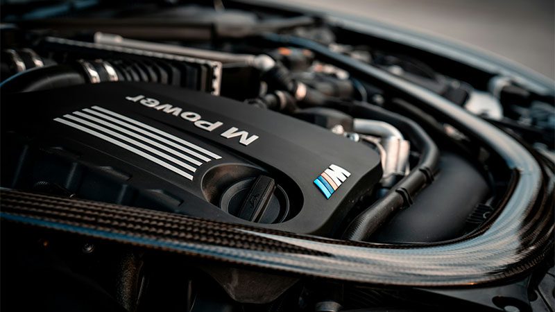 Close-up of a BMW engine, emphasizing premium engineering and performance reliability.