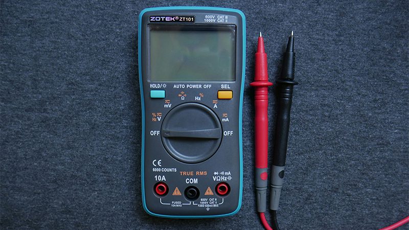 Using a multimeter to check the voltage and resistance of a malfunctioning crankshaft position sensor.