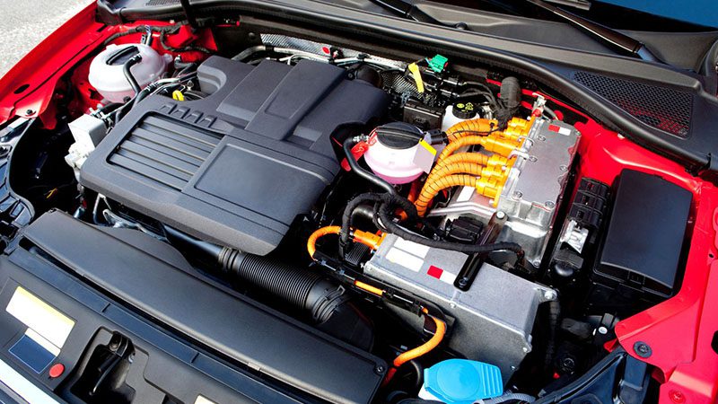 Close-up view of two engines—electric and gasoline—in a hybrid car