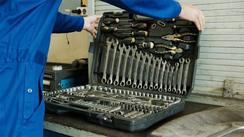 Assortment of automotive repair tools for diagnosing and repairing P0016 code engine issue.