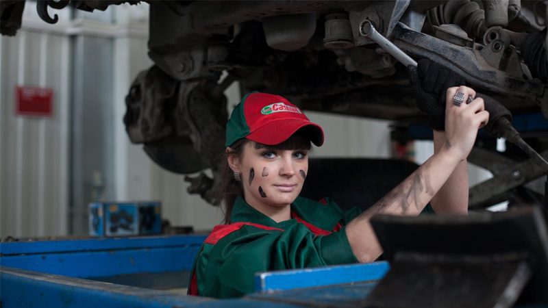 Mechanic standing ready to work on car repairs in a garage.