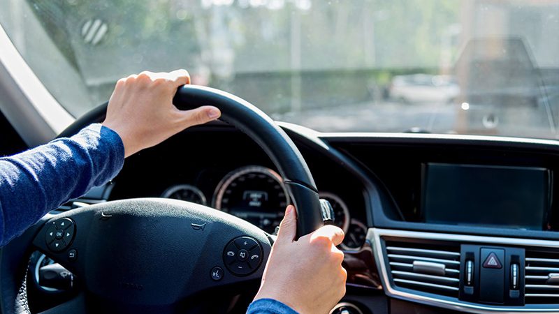 Driver maintaining a smooth and steady speed, practicing safe driving habits to improve fuel efficiency.