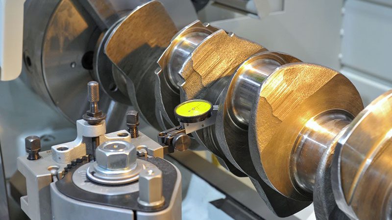 Crankshaft positioned for inspection, highlighting precision measurement and surface detail